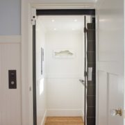 Custom designed cab showing matching flooring from hallway into elevator. *Note – this gate style is no longer available